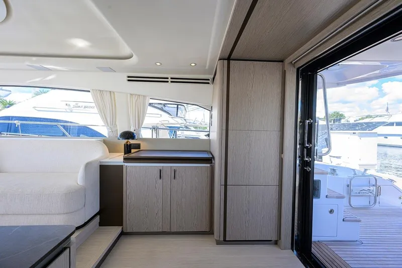Bg 53 Yacht Photos Pics Luxurious interior of 2024 Azimut 53 Fly yacht with modern furnishings and marina view.