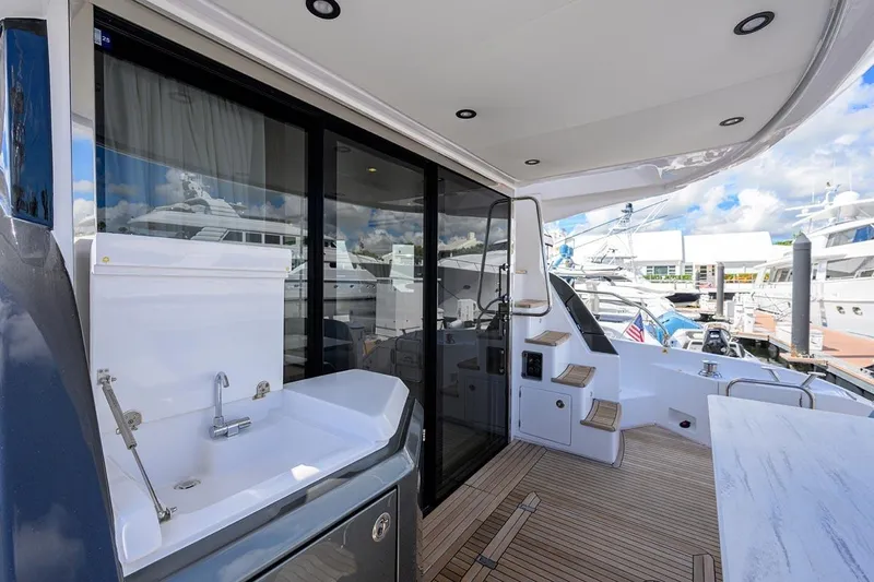 Bg 53 Yacht Photos Pics 2024 Azimut 53 Fly yacht deck with sink, modern design, and marina view.