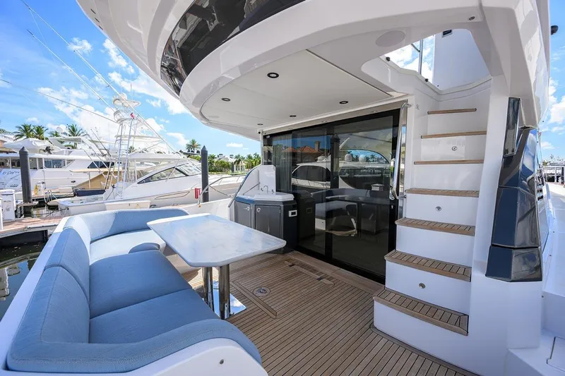 Bg 53 Yacht Photos Pics Luxurious 2024 Azimut 53 Fly yacht deck with seating and staircase.