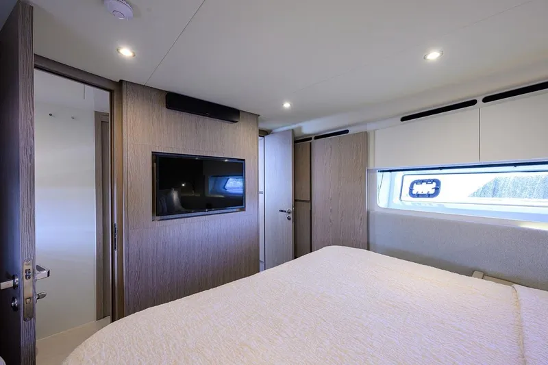 Bg 53 Yacht Photos Pics Luxurious bedroom interior of 2024 Azimut 53 Fly yacht with modern design and window view.