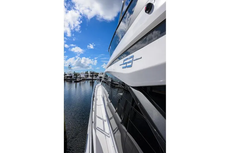 Bg 53 Yacht Photos Pics 2024 Azimut 53 Fly yacht docked, showcasing sleek design under a vibrant blue sky.