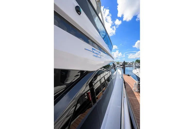 Bg 53 Yacht Photos Pics Side view of 2024 Azimut 53 Fly yacht docked under a clear blue sky.