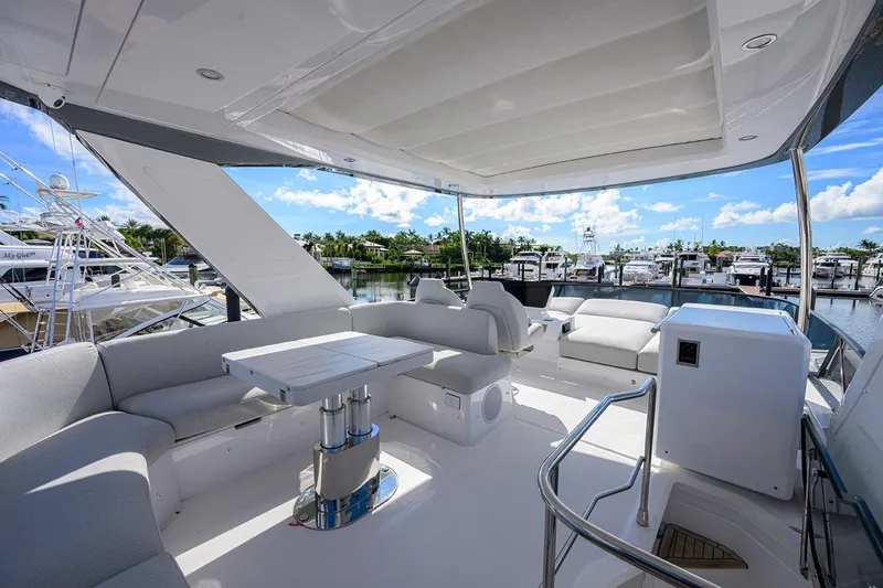 Bg 53 Yacht Photos Pics Luxurious 2024 Azimut 53 Fly yacht interior with elegant seating and marina view.