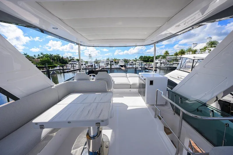 Bg 53 Yacht Photos Pics Luxurious 2024 Azimut 53 Fly yacht interior with elegant seating and marina view.