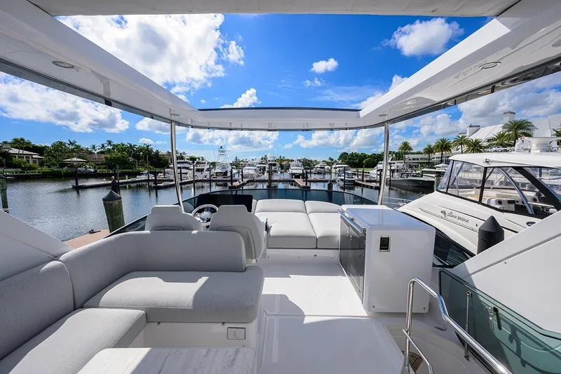 Bg 53 Yacht Photos Pics Luxurious 2024 Azimut 53 Fly yacht interior with marina view, featuring elegant seating and modern design.