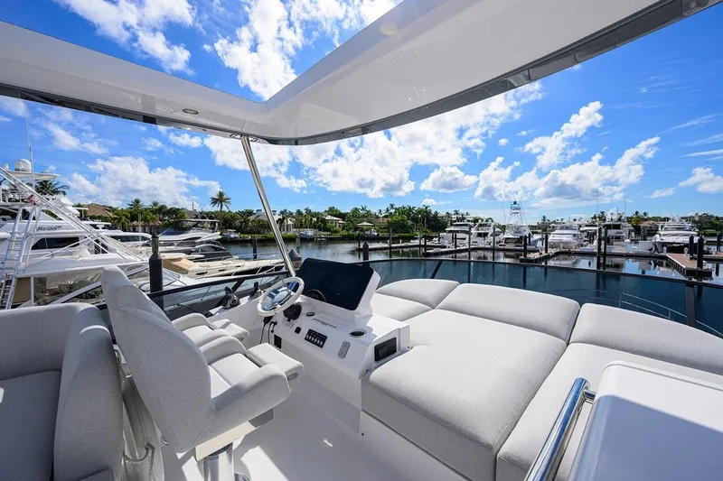 Bg 53 Yacht Photos Pics 2024 Azimut 53 Fly yacht interior with luxurious seating and marina view.