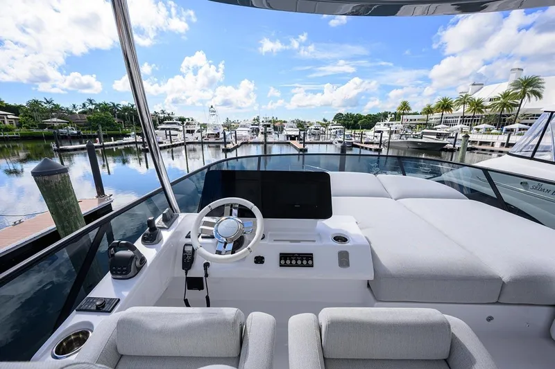 Bg 53 Yacht Photos Pics 2024 Azimut 53 Fly yacht helm with marina view, featuring modern controls and luxurious seating.