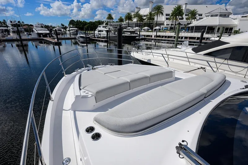 Bg 53 Yacht Photos Pics 2024 Azimut 53 Fly yacht with spacious sunbathing area in a marina setting.