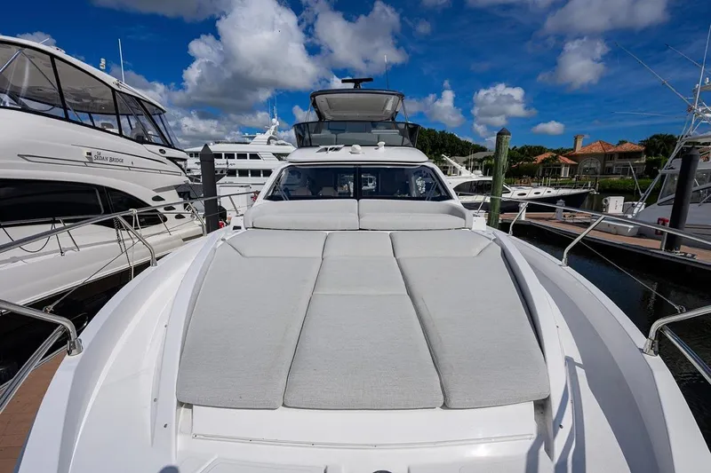 Bg 53 Yacht Photos Pics 2024 Azimut 53 Fly yacht with spacious sunbathing area, docked at marina.