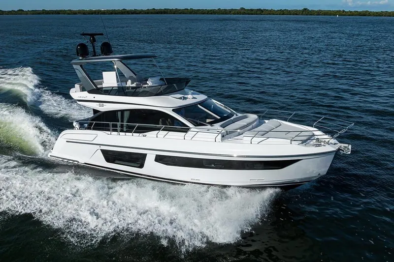Bg 53 Yacht Photos Pics 2024 Azimut 53 Fly yacht cruising on open water, showcasing sleek design and luxury.