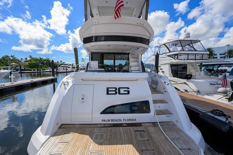 Bg 53 Yacht Photos Pics 2024 Azimut 53 Fly yacht docked in Palm Beach, Florida, under a clear blue sky.