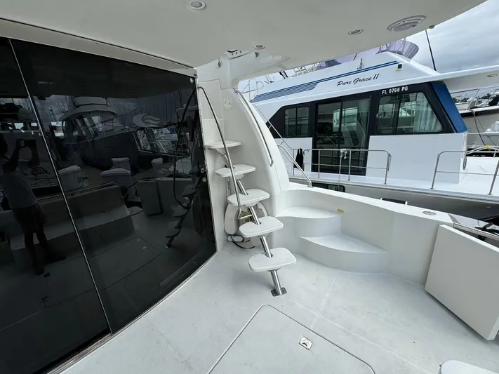 Endymion Yacht Photos Pics 2006 Carver 56 Voyager yacht deck with spiral staircase and docked boat view.