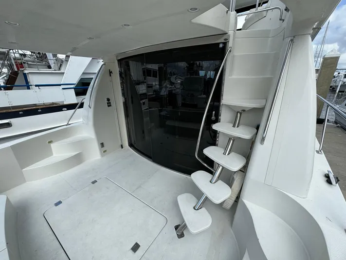 Endymion Yacht Photos Pics 2006 Carver 56 Voyager yacht with sleek white interior and spiral staircase.