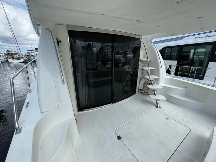 Endymion Yacht Photos Pics 2006 Carver 56 Voyager yacht deck with sliding glass door and spiral staircase.