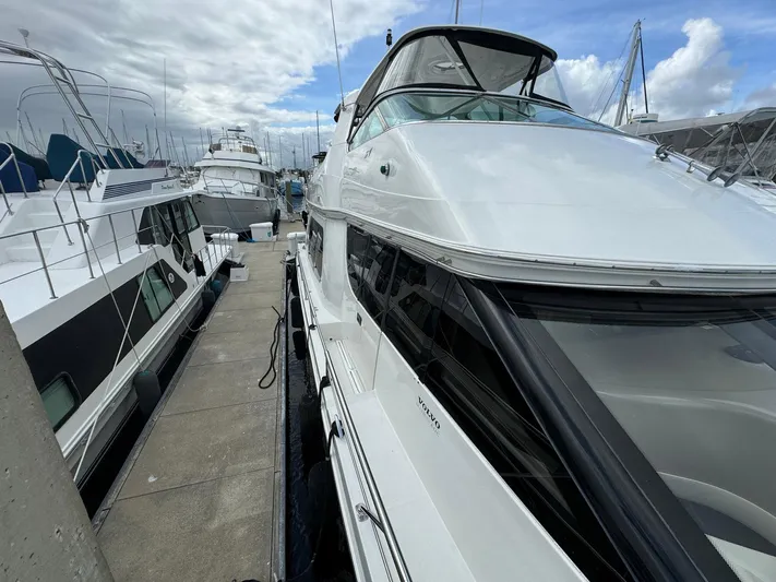 Endymion Yacht Photos Pics 2006 Carver 56 Voyager yacht docked at marina under cloudy sky.