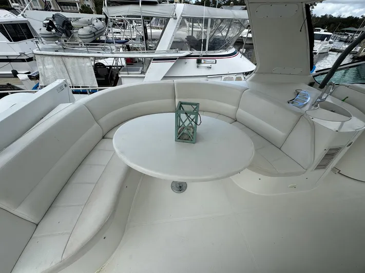 Endymion Yacht Photos Pics 2006 Carver 56 Voyager yacht with white seating and table on deck.