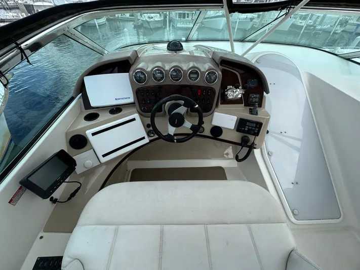 Endymion Yacht Photos Pics Helm of 2006 Carver 56 Voyager yacht with steering wheel and navigation instruments.
