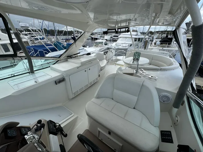 Endymion Yacht Photos Pics 2006 Carver 56 Voyager yacht interior with white seating and control panel at marina.