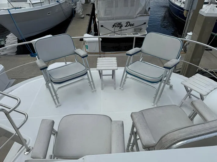 Endymion Yacht Photos Pics 2006 Carver 56 Voyager yacht deck with chairs and small tables at marina.