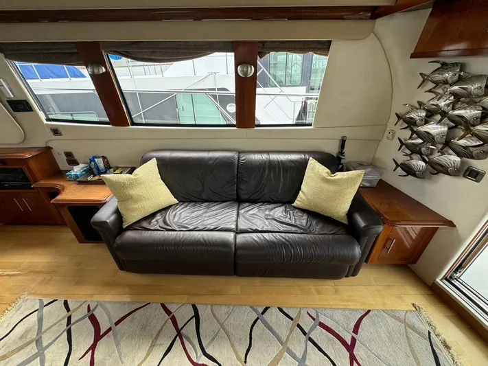 Endymion Yacht Photos Pics Luxurious interior of 2006 Carver 56 Voyager yacht with leather sofa and decorative pillows.