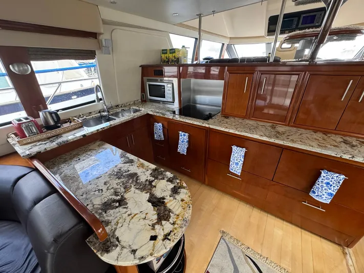 Endymion Yacht Photos Pics Luxurious kitchen in 2006 Carver 56 Voyager yacht with granite countertops and modern appliances.