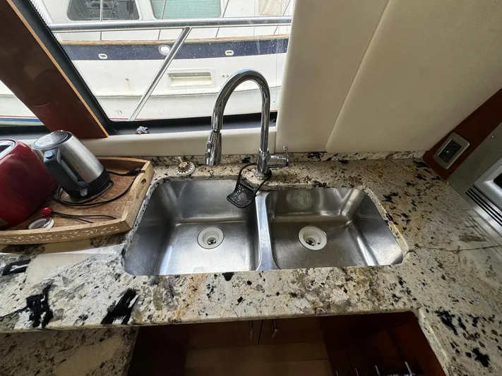 Endymion Yacht Photos Pics Granite countertop with double sink in 2006 Carver 56 Voyager yacht kitchen.