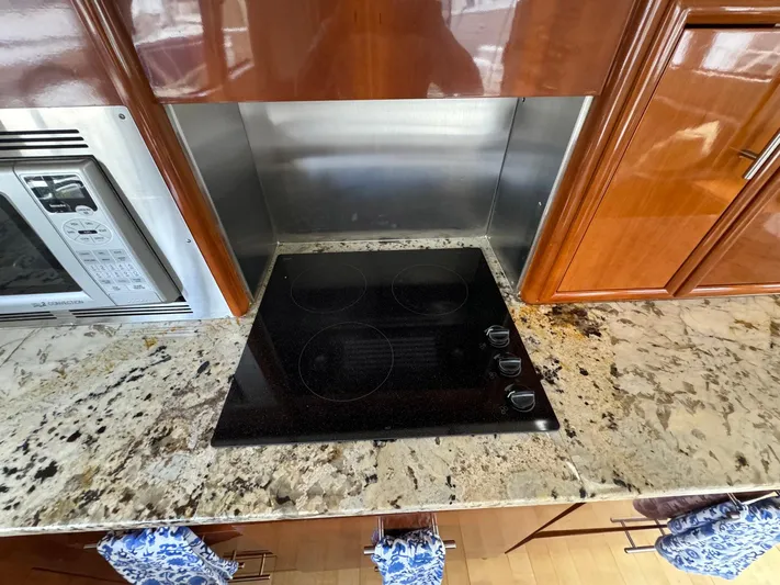 Endymion Yacht Photos Pics Modern kitchen in 2006 Carver 56 Voyager yacht with granite countertop and electric cooktop.