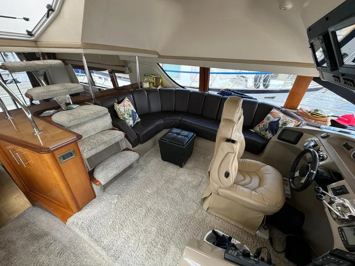 Endymion Yacht Photos Pics Luxurious interior of a 2006 Carver 56 Voyager yacht with plush seating and modern helm.