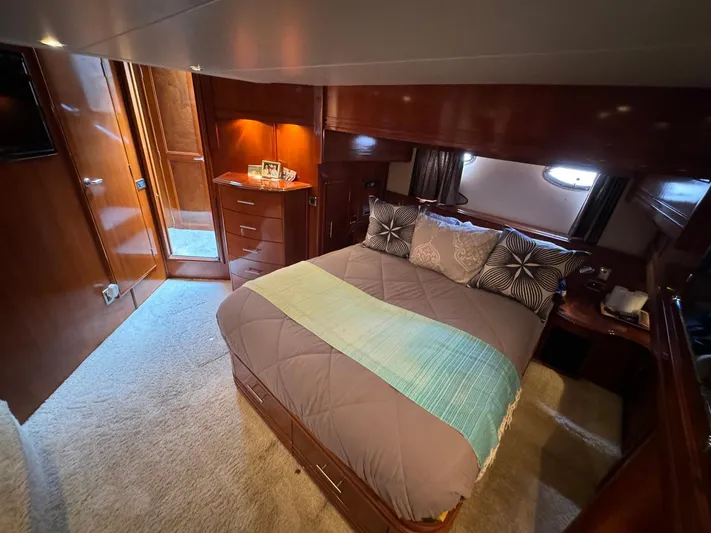 Endymion Yacht Photos Pics Luxurious bedroom interior of 2006 Carver 56 Voyager yacht with elegant wood finishes.