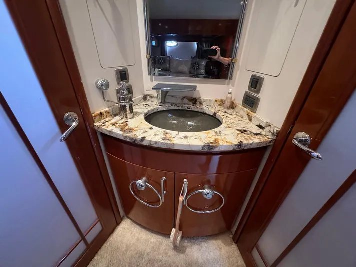 Endymion Yacht Photos Pics Luxurious bathroom vanity in 2006 Carver 56 Voyager yacht with marble countertop and modern fixtures.
