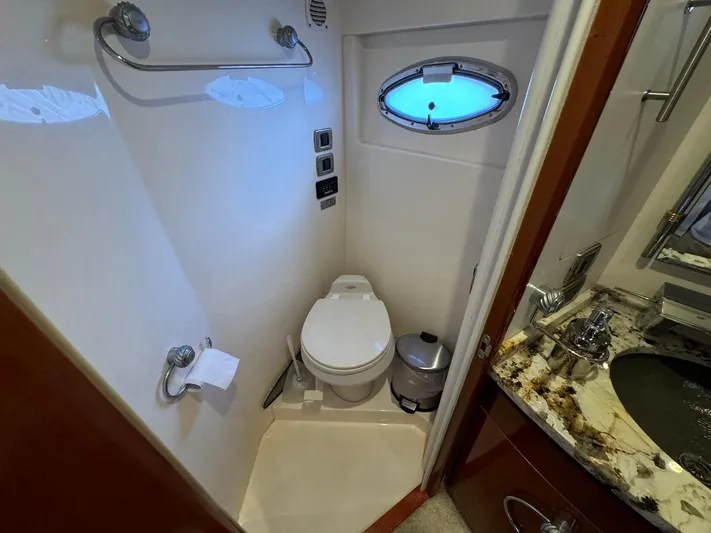 Endymion Yacht Photos Pics 2006 Carver 56 Voyager yacht bathroom with toilet, sink, and porthole window.