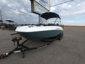 2024 Tahoe T21 boat on trailer at dealership.