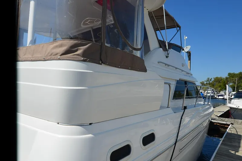 Stage III Yacht Photos Pics 2001 Cruisers Yachts 3750 Motoryacht docked under clear blue sky.