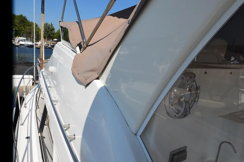 Stage III Yacht Photos Pics 2001 Cruisers Yachts 3750 Motoryacht side view with canopy, docked at marina.