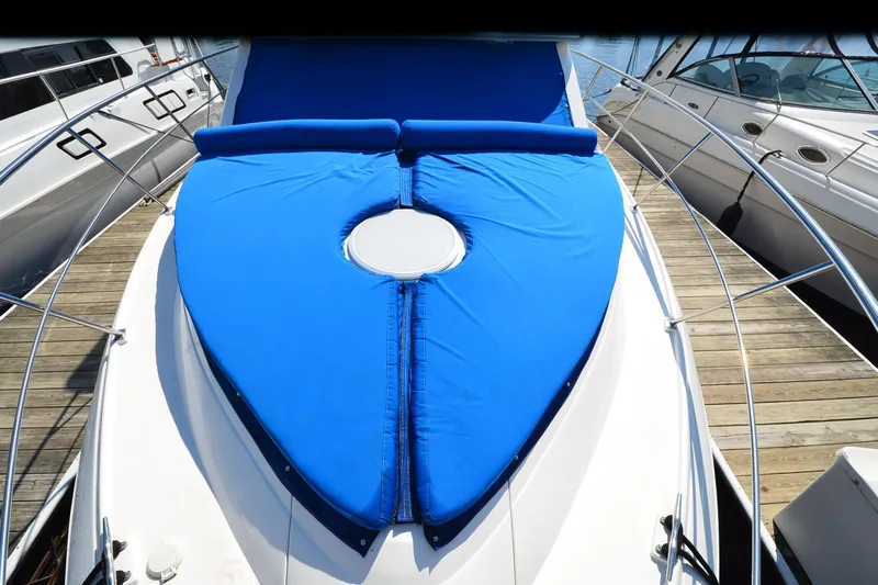Stage III Yacht Photos Pics 2001 Cruisers Yachts 3750 Motoryacht with blue deck cover at marina.