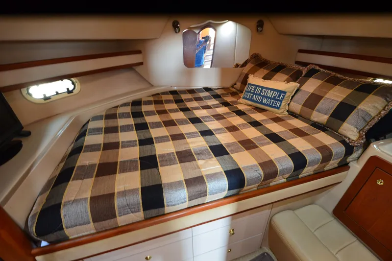 Stage III Yacht Photos Pics Luxurious cabin interior of 2001 Cruisers Yachts 3750 Motoryacht with plaid bedding.