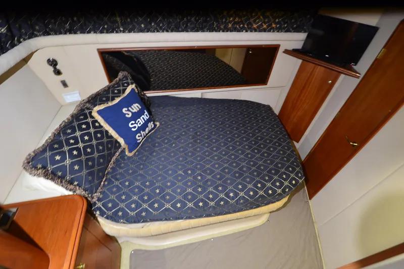 Stage III Yacht Photos Pics Luxurious bedroom in 2001 Cruisers Yachts 3750 Motoryacht with nautical-themed bedding.