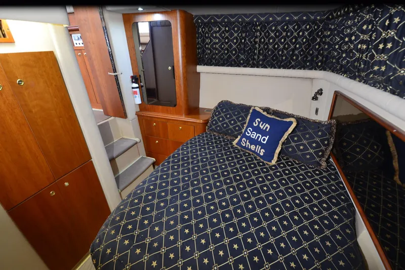 Stage III Yacht Photos Pics Luxurious 2001 Cruisers Yachts 3750 Motoryacht cabin with nautical-themed bedding.