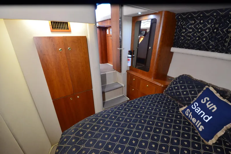 Stage III Yacht Photos Pics Interior of 2001 Cruisers Yachts 3750 Motoryacht with cozy bedroom and wooden cabinetry.