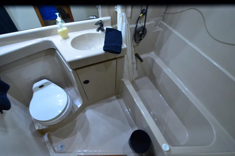 Stage III Yacht Photos Pics Bathroom interior of 2001 Cruisers Yachts 3750 Motoryacht with sink, toilet, and bathtub.