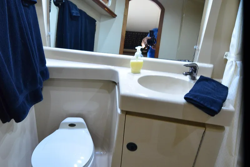 Stage III Yacht Photos Pics Bathroom interior of 2001 Cruisers Yachts 3750 Motoryacht with sink and toilet.