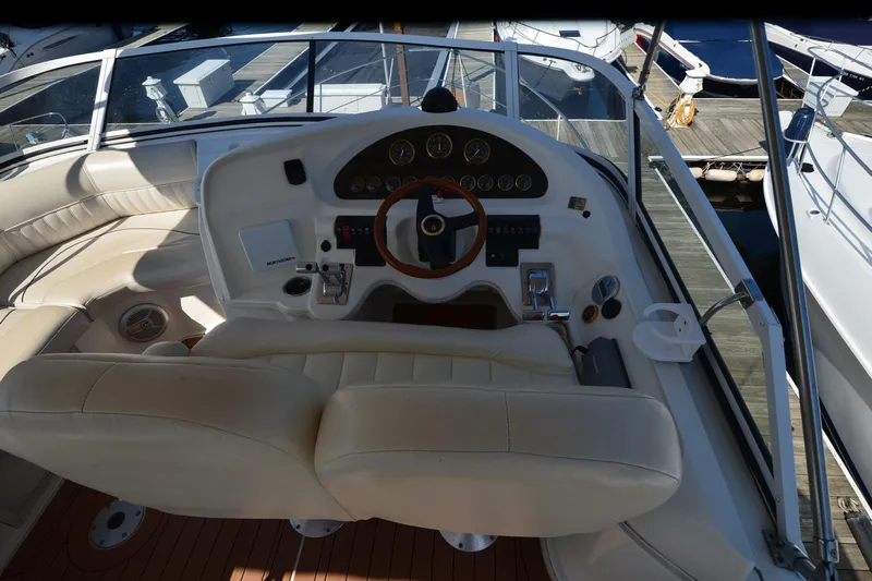 Stage III Yacht Photos Pics 2001 Cruisers Yachts 3750 Motoryacht helm with leather seats and wooden steering wheel.