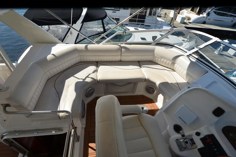 Stage III Yacht Photos Pics 2001 Cruisers Yachts 3750 Motoryacht cockpit with white seating and control panel.