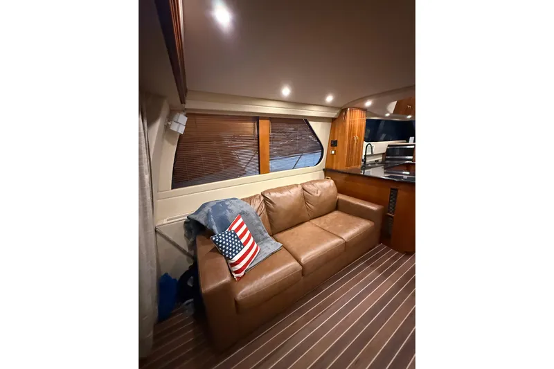 Orion Yacht Photos Pics Luxurious interior of 2004 Carver 460 Voyager yacht with leather sofa and American flag pillow.