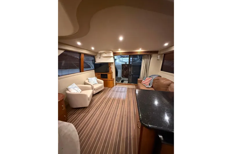 Orion Yacht Photos Pics Luxurious interior of 2004 Carver 460 Voyager yacht with elegant seating and wood flooring.