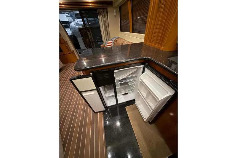 Orion Yacht Photos Pics 2004 Carver 460 Voyager yacht interior with open refrigerator and sleek countertops.