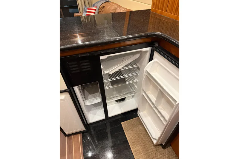 Orion Yacht Photos Pics 2004 Carver 460 Voyager yacht kitchen with open refrigerator and sleek countertops.