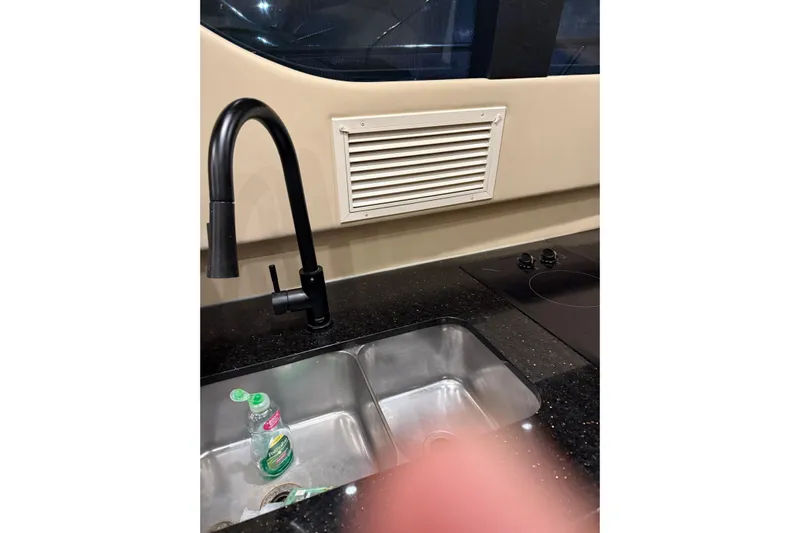 Orion Yacht Photos Pics Kitchen area of 2004 Carver 460 Voyager with sink, faucet, and stove.