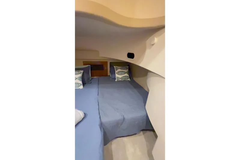 Orion Yacht Photos Pics Interior cabin of 2004 Carver 460 Voyager yacht with blue bedding and decorative pillows.