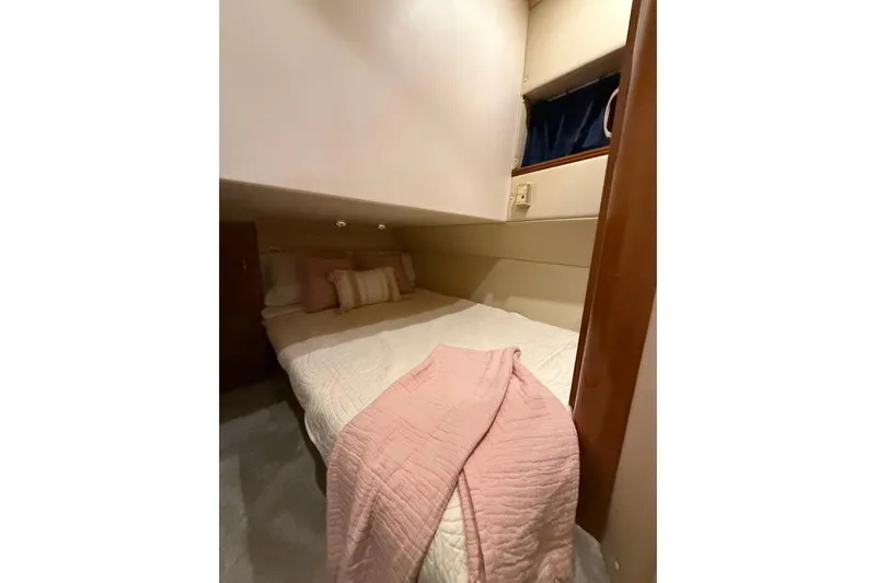 Orion Yacht Photos Pics 2004 Carver 460 Voyager cabin with cozy bed and soft pink bedding.